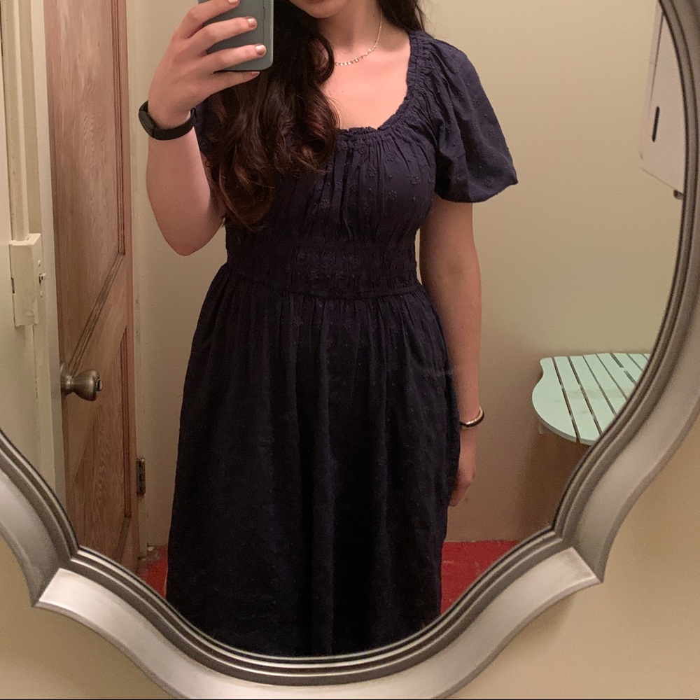 Navy blue dress with puff sleeves that falls below the knee